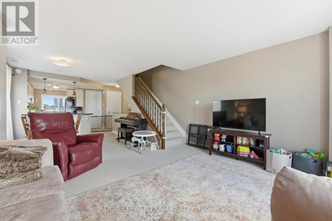 A living room with a red chair and a television.