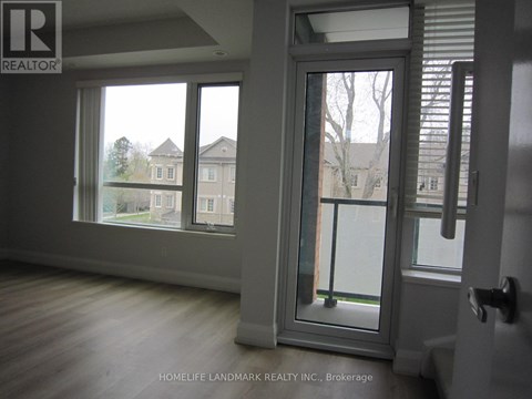 A room with a sliding glass door leading to a balcony.