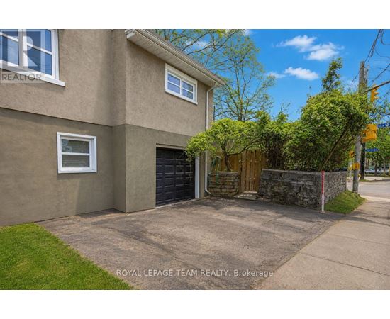 A house with a garage and a sign that says "REALTOR".