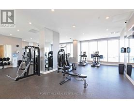 A gym with a variety of equipment including treadmills, weights, and exercise machines.