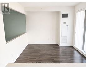 A room with a blackboard on the wall and a white door.
