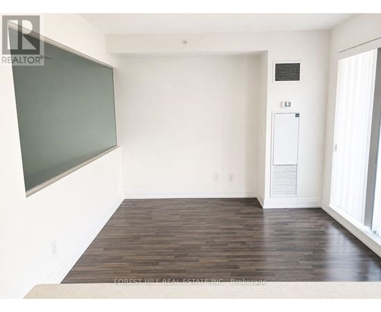 A room with a blackboard on the wall and a white door.