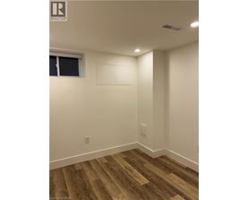 A room with wood flooring and white walls.