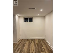A room with wooden flooring and a window.