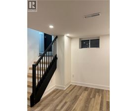 A room with a staircase and a window.