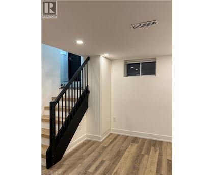 A room with a staircase and a window.