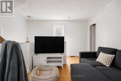 A living room with a grey couch and a flat screen TV.