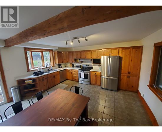 A kitchen with wooden cabinets and a large island.