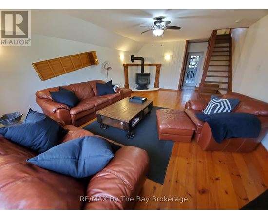 A living room with brown leather couches and a wooden coffee table.