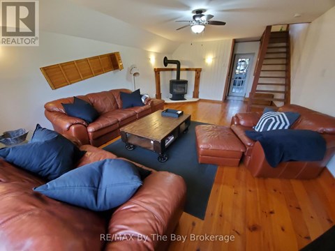 A living room with brown leather couches and a wooden coffee table.