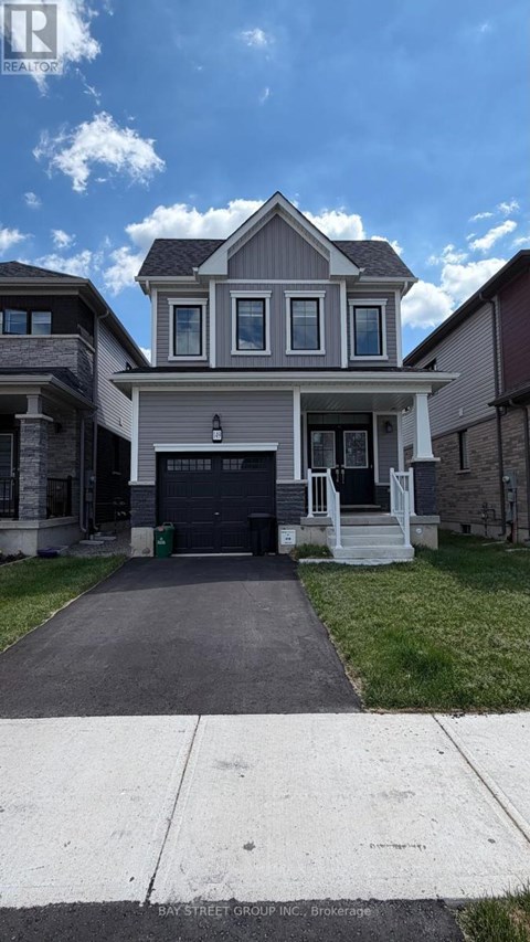A two-story house with a garage is located in a residential area.