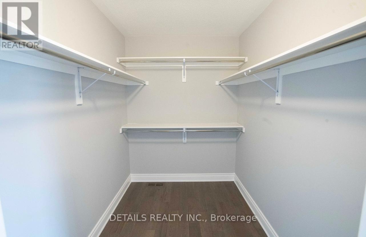 A white bedroom with a bed and a shelf.