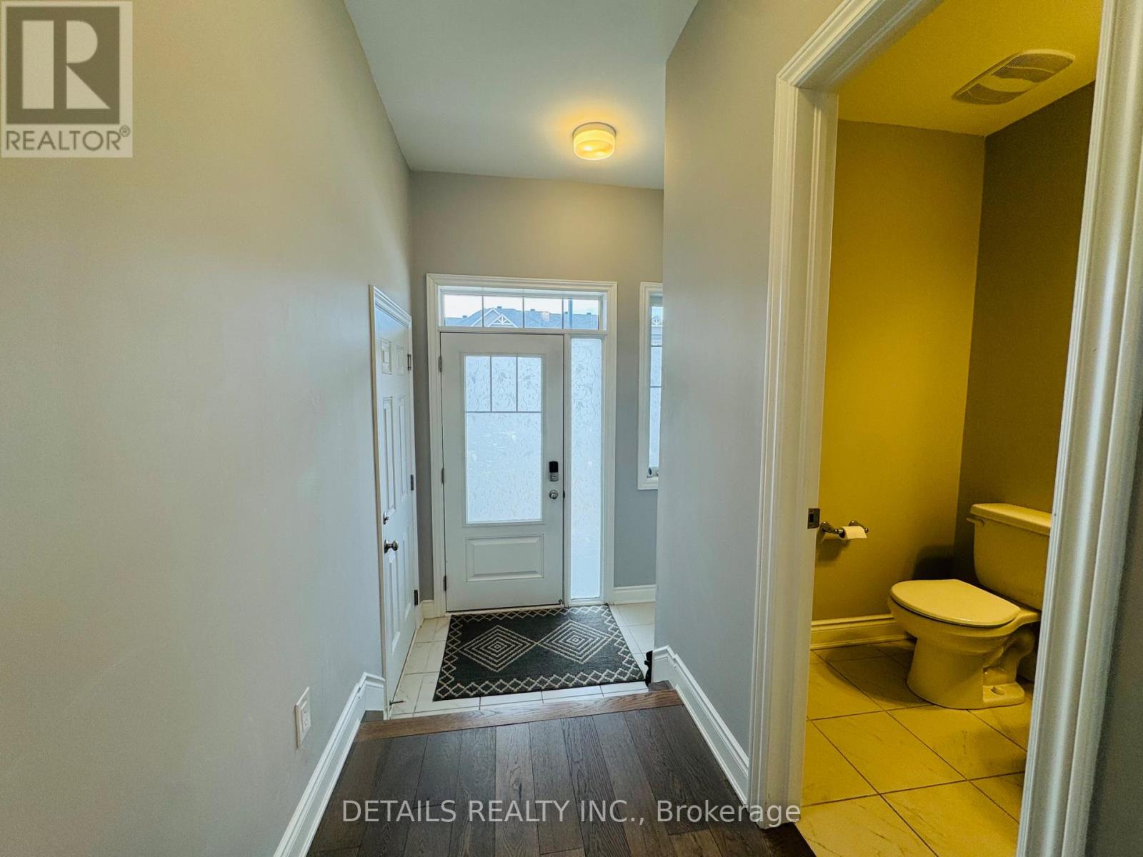 A hallway with a door leading to a bathroom.