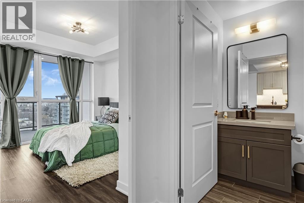A bedroom with a large bed and a vanity with a mirror.