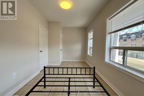 A bedroom with a bed in the middle of the room.