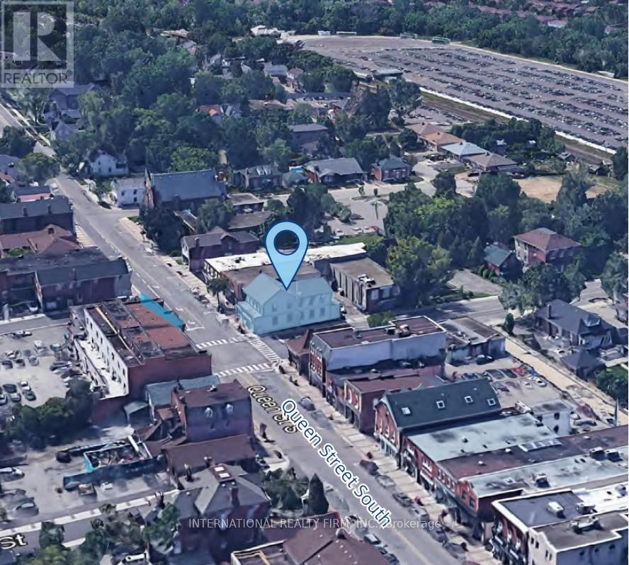 A blue marker is placed on a street in a small town.