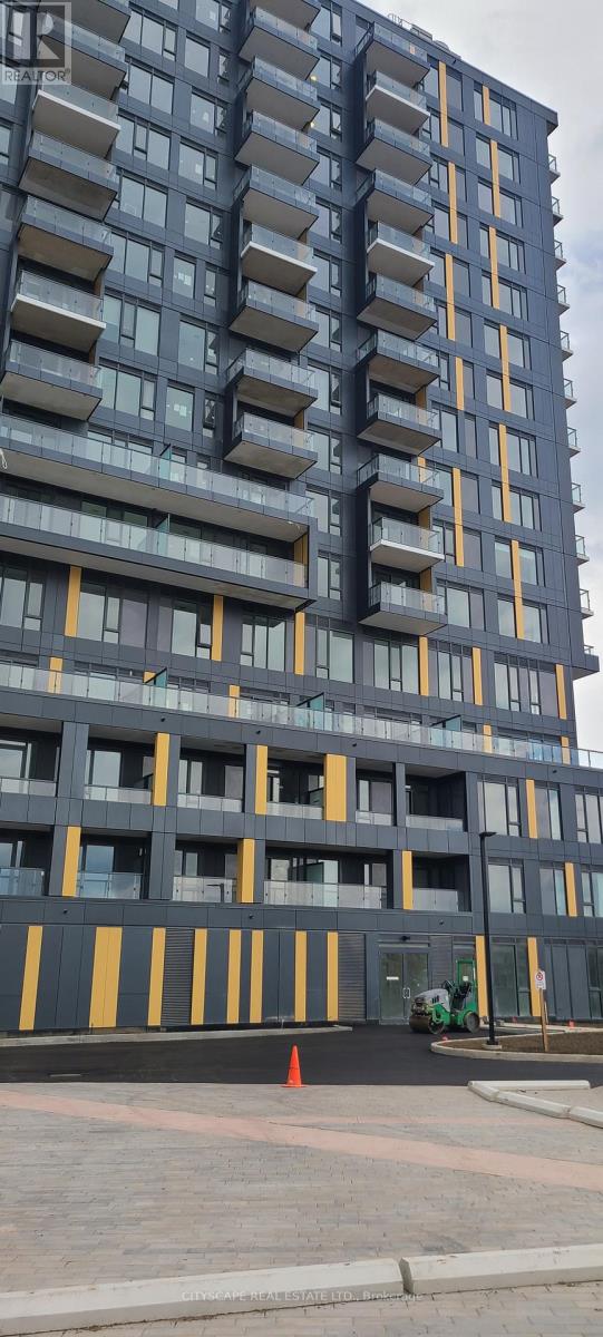 A tall building with balconies and a yellow stripe on the ground.