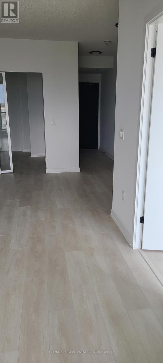 A room with a white door and a white wall.