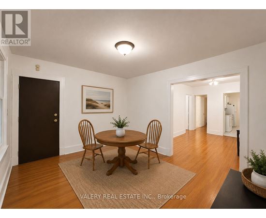 A dining room with a wooden table and chairs.