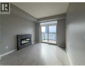 A spacious living room with a fireplace and sliding glass doors leading to a balcony.