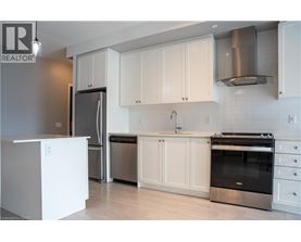 A kitchen with white cabinets and stainless steel appliances.
