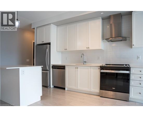A kitchen with white cabinets and stainless steel appliances.