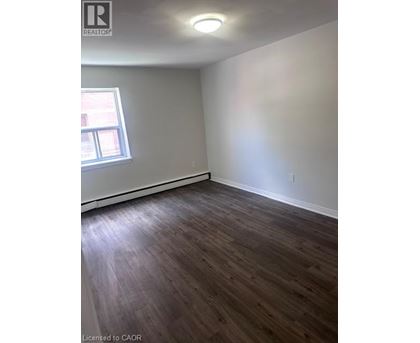 A room with wooden flooring and a window.