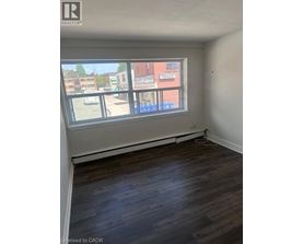 Empty room with a window overlooking a street.