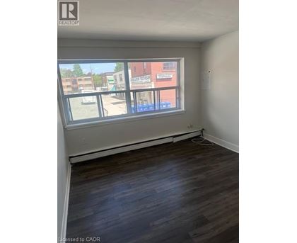 Empty room with a window overlooking a street.