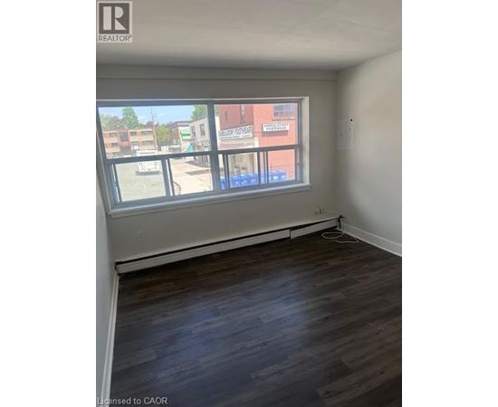 Empty room with a window overlooking a street.