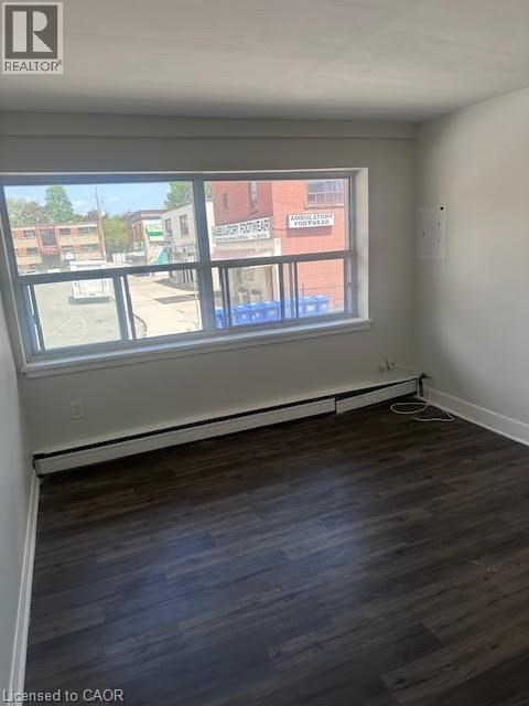 Empty room with a window overlooking a street.