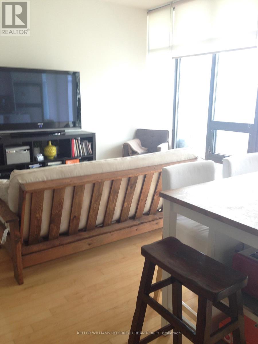 A living room with a white couch and a wooden table.