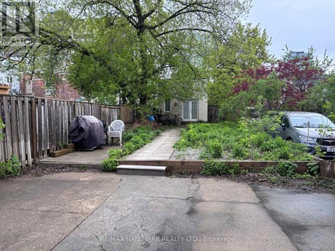 A backyard with a wooden fence and a small garden area.