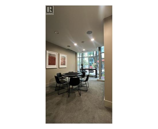 A conference room with a table and chairs.