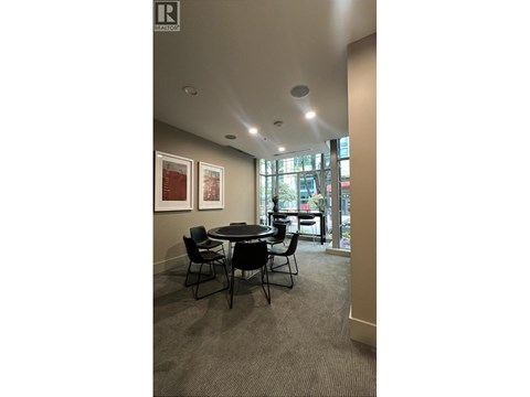 A conference room with a table and chairs.