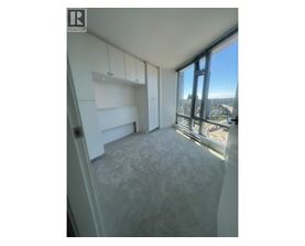 A room with a large window overlooking a cityscape.