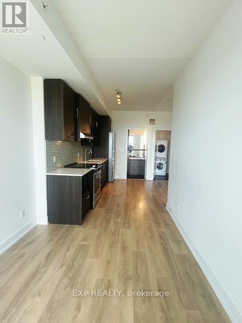 A kitchen with wooden floors and white walls.