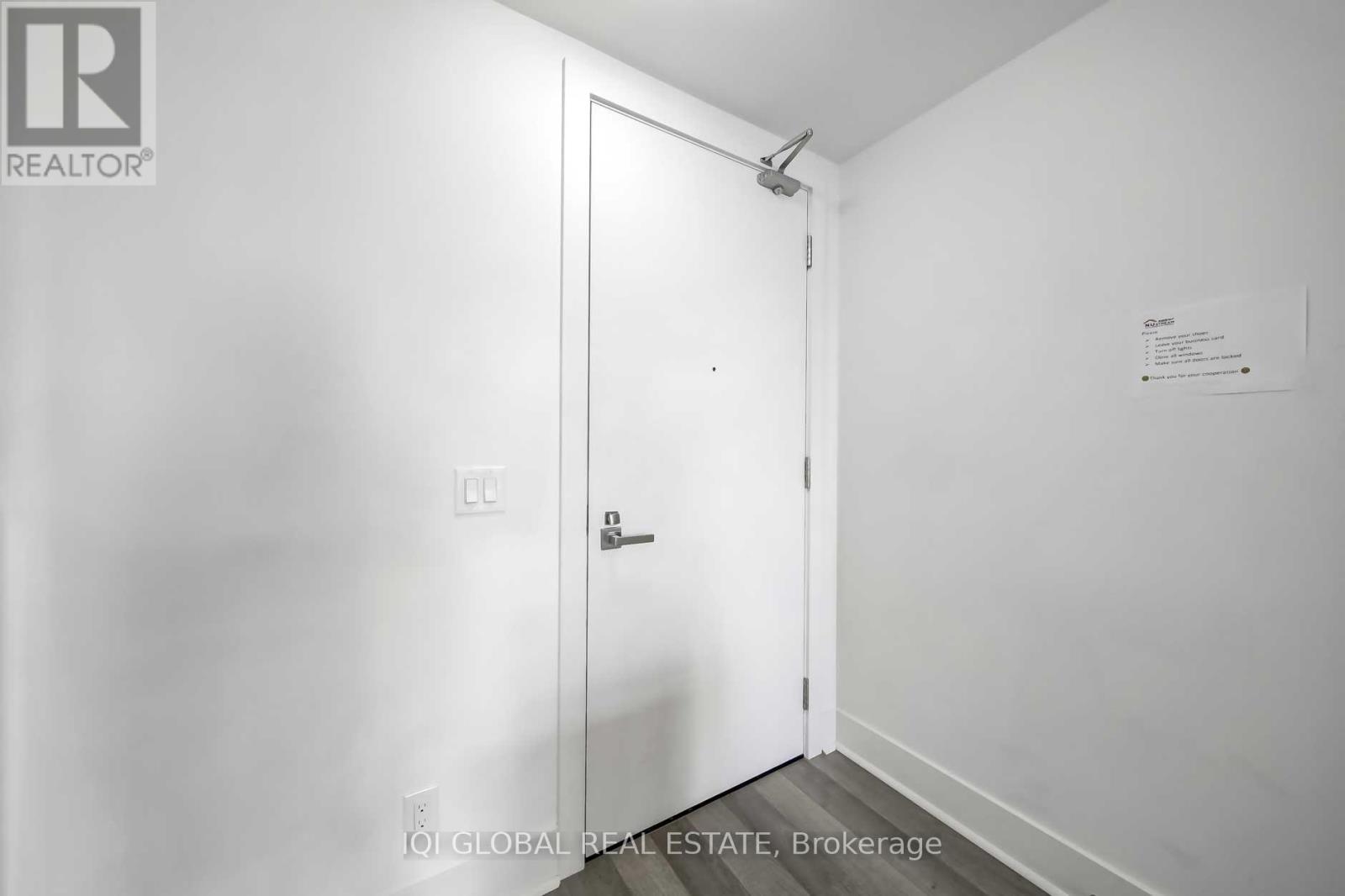 A white door with a sign on the wall.