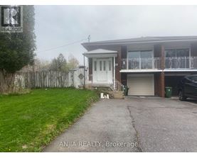 A house with a white door and a balcony is for sale.