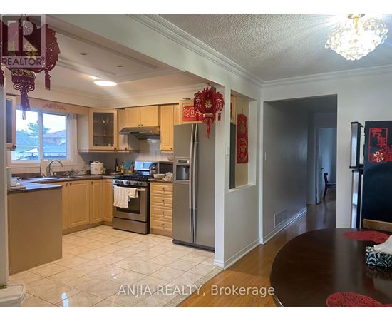 A kitchen with a dining table and a chandelier.