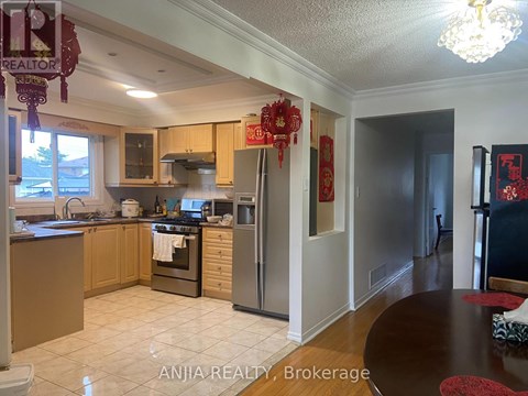 A kitchen with a dining table and a chandelier.