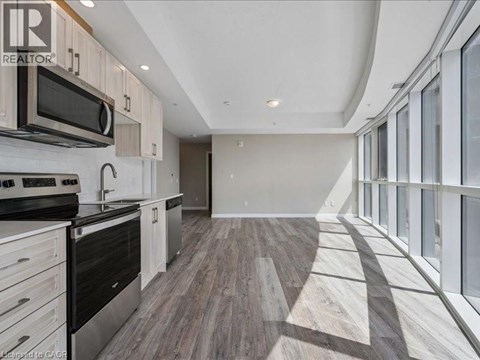 A modern kitchen with a stainless steel oven and microwave.
