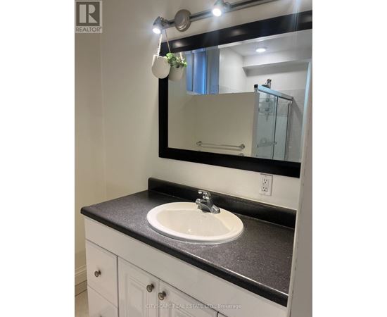A bathroom sink with a mirror above it.