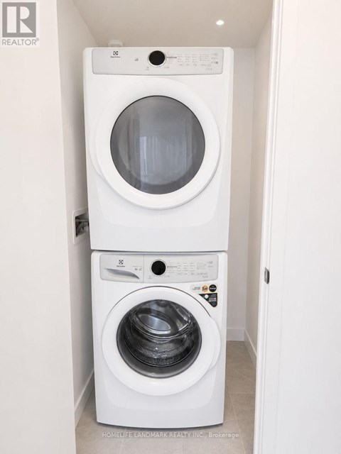 A white washing machine and dryer in a small laundry room.