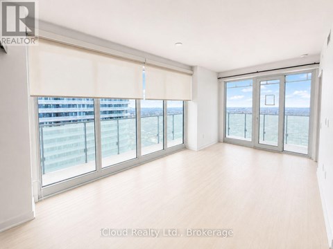 A spacious room with large windows and sliding glass doors.