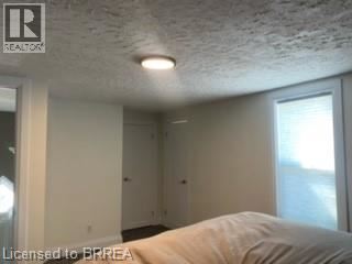 A room with a bed and a window.