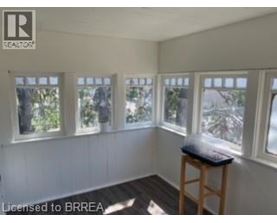 A room with white walls and a wooden stool.