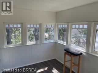 A room with white walls and a wooden stool.
