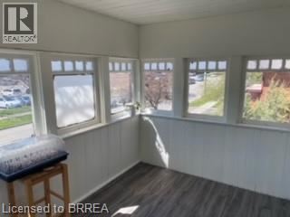 A room with a window seat and a view of the outside.