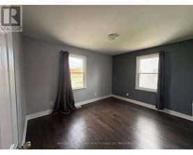 A room with a window and a curtain.